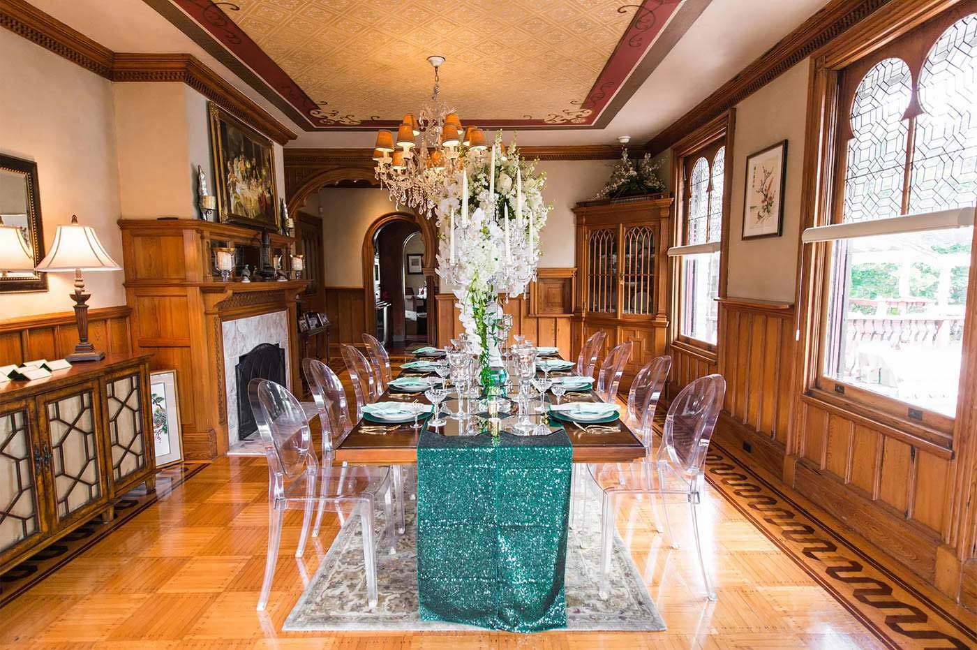 A candlelit table set for dinner on the mansion veranda