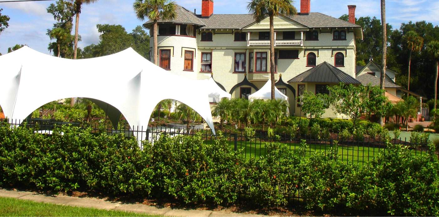 An event tent on the mansion grounds beside the house