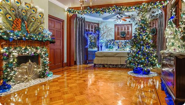 A decorated fireplace and nativity scene inside the Mansion