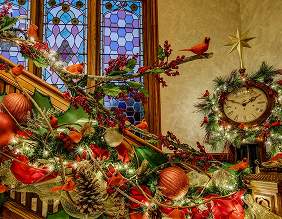 Christmas decorations beside a stained glass window