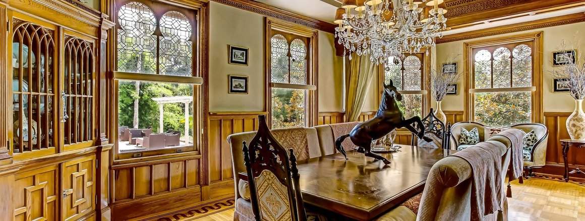 The dining room, panelled in original wood with leaded glass windows