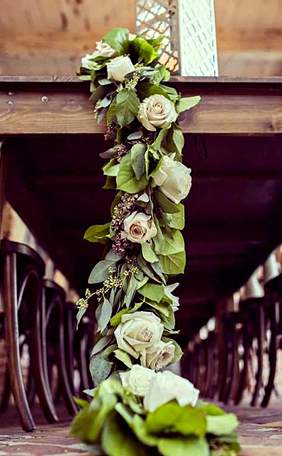 A garland of roses and greenery draped above the room