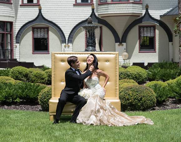 A couple photographed on the lawn in front of the Mansion