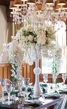A white floral centerpiece on the reception table