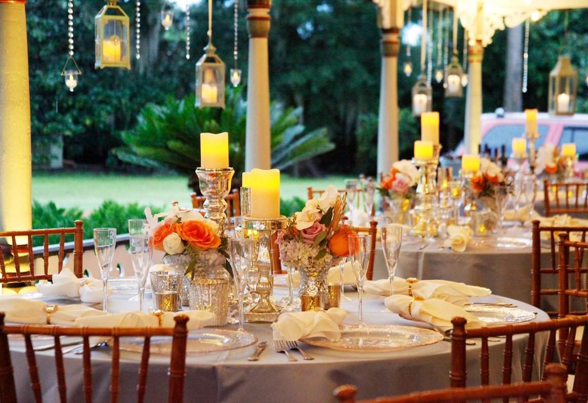 A garden table set with candles and lanterns