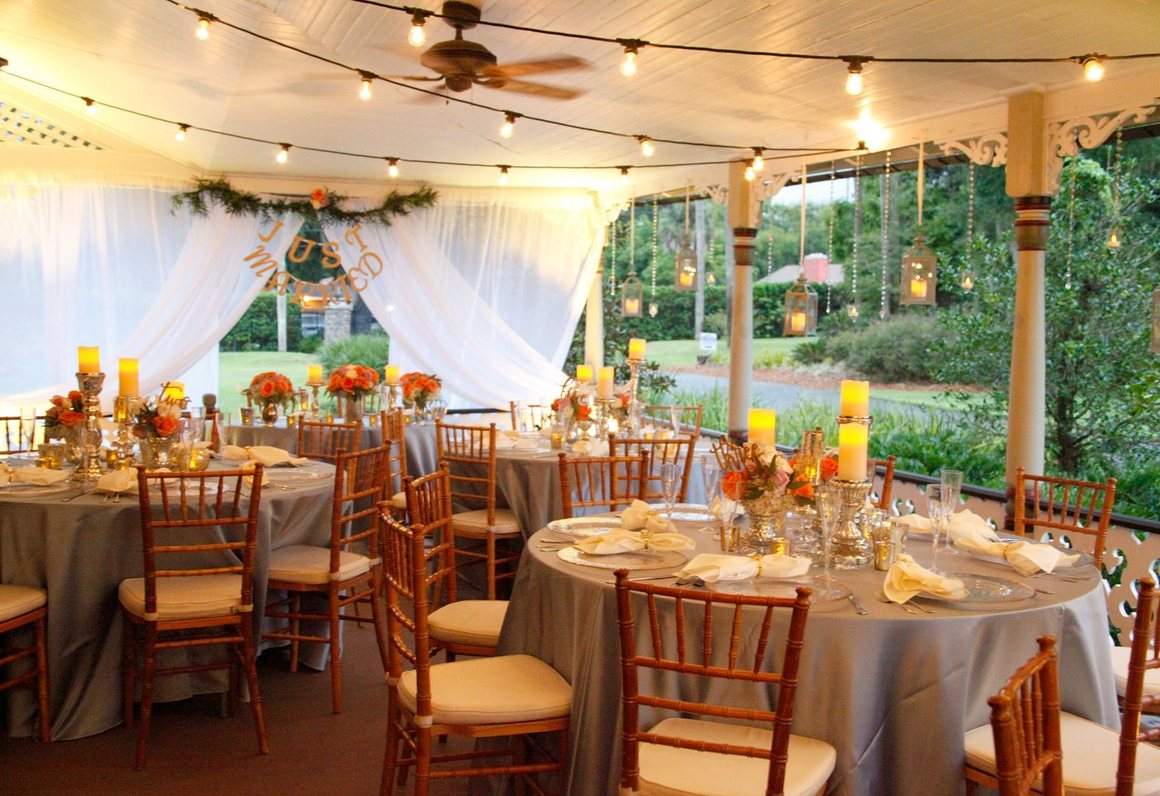 Reception tables under the wraparound porch