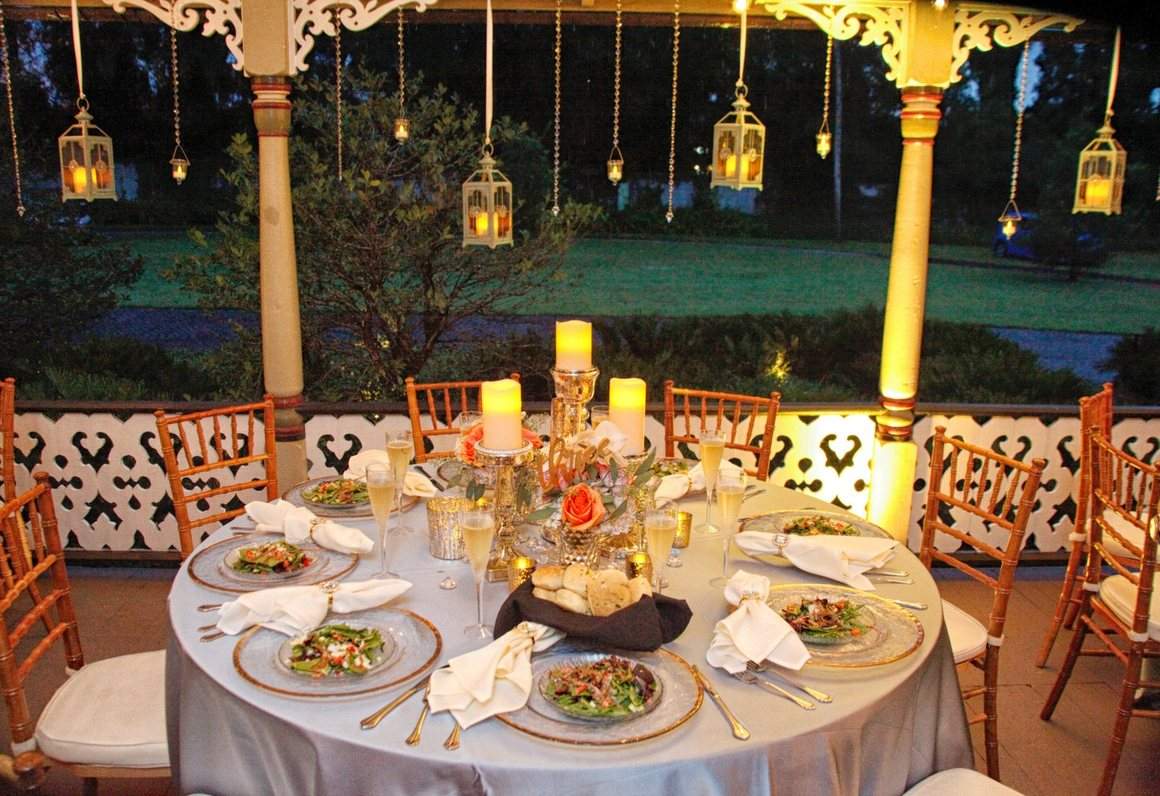 An evening table setting lit by lanterns